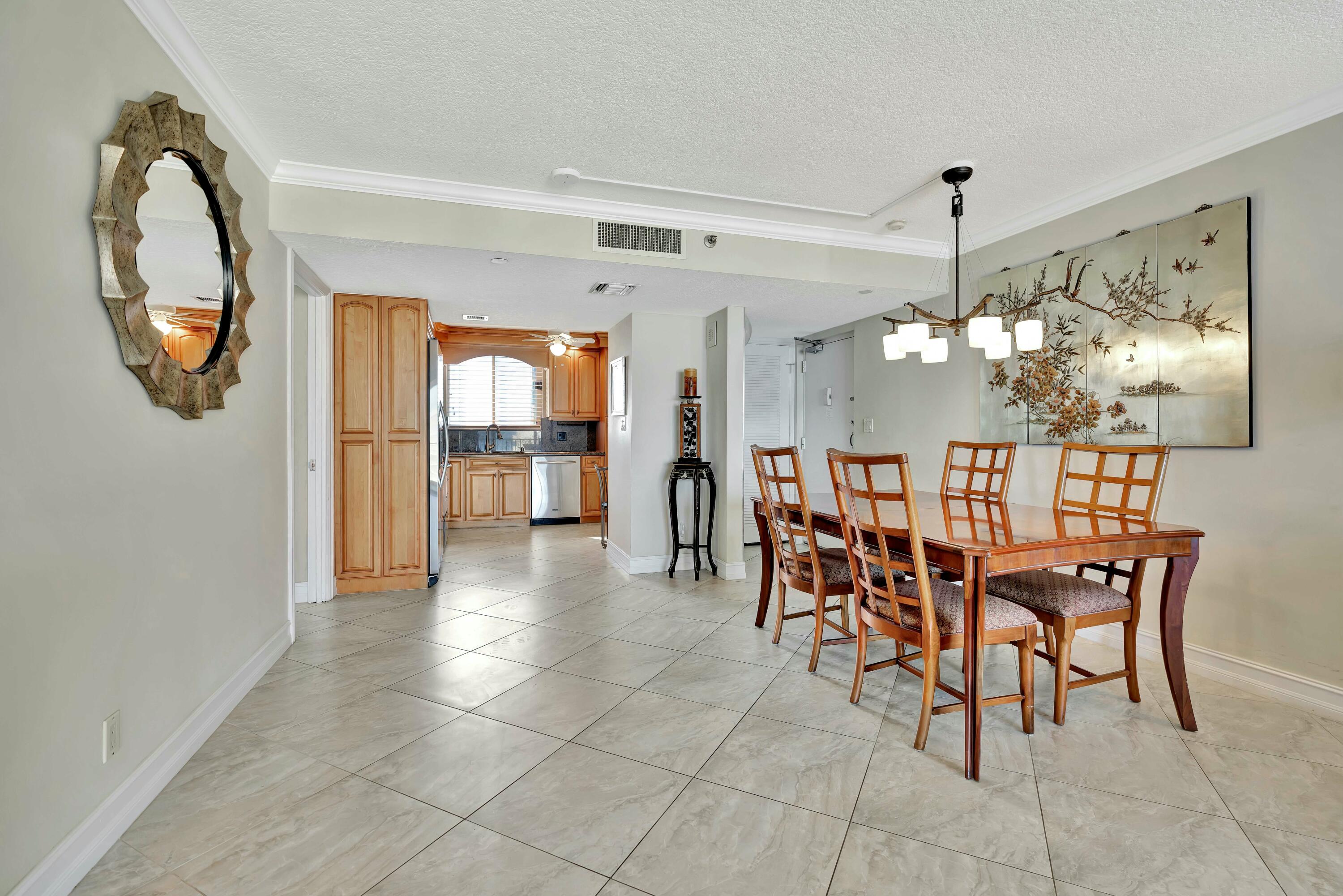 100 Ocean Trail Way, Unit 1201 Jupiter, FL 33477 - Photo 11 of 61 a view of a dining room with furniture and a chandelier