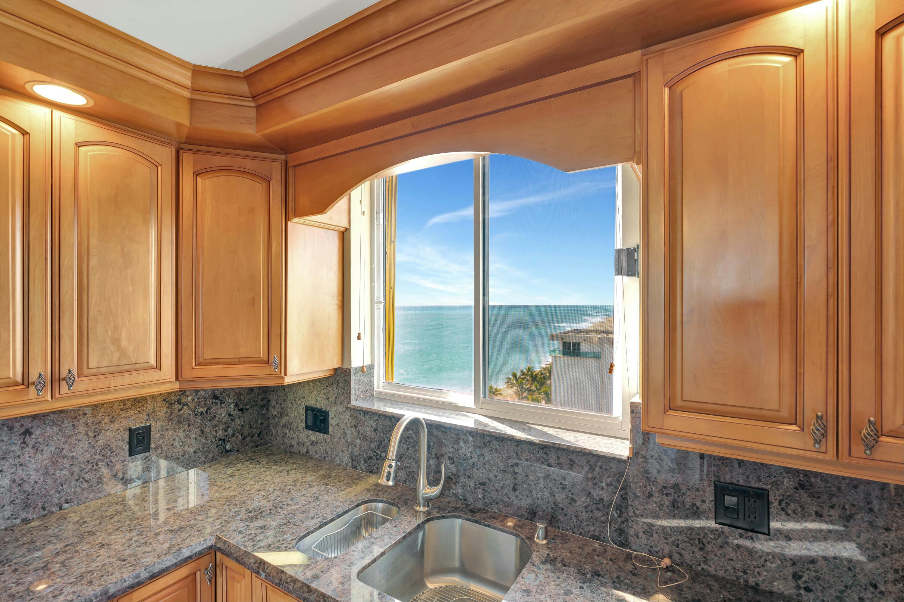 100 Ocean Trail Way, Unit 1201 Jupiter, FL 33477 - Photo 13 of 61 a kitchen with granite countertop a sink and a window