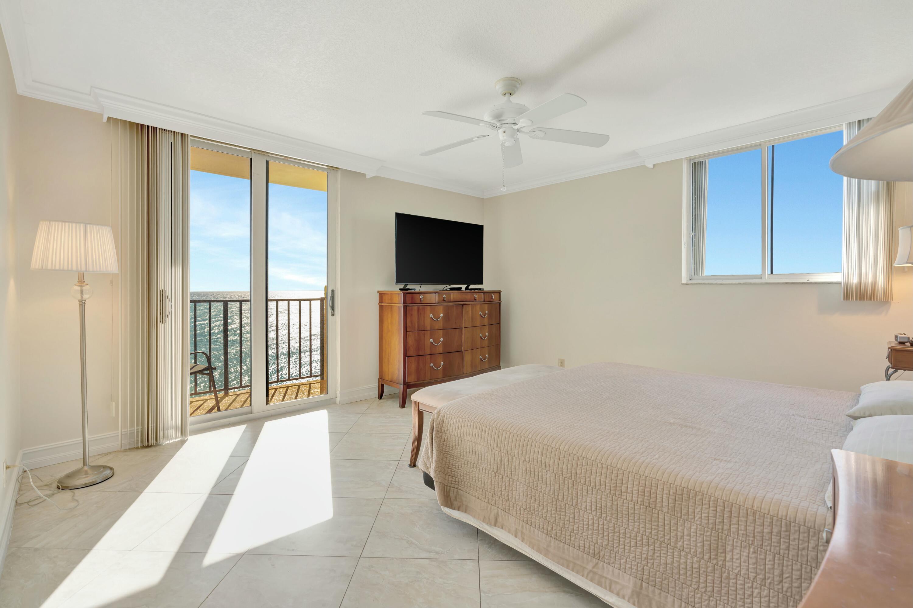 100 Ocean Trail Way, Unit 1201 Jupiter, FL 33477 - Photo 16 of 61 a spacious bedroom with a large bed and a tv