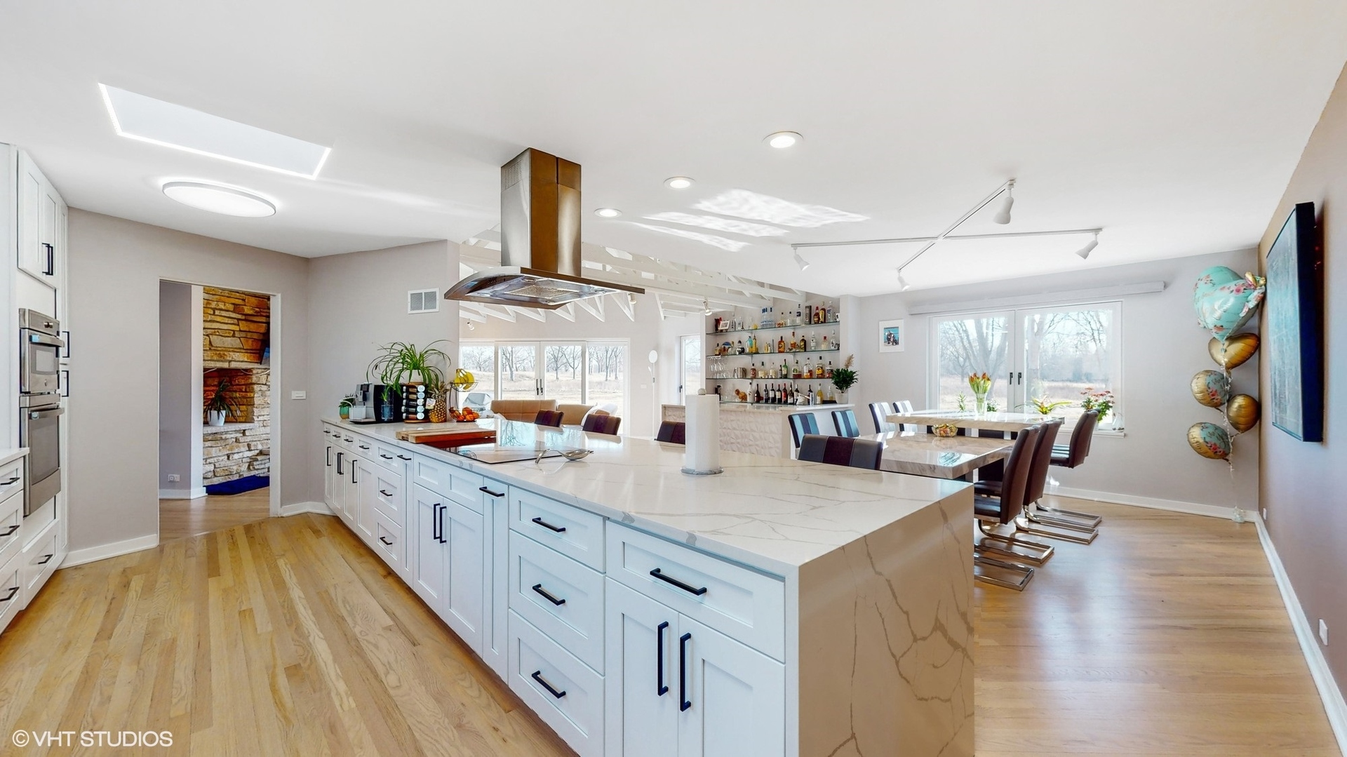 711 Lee Road Northbrook, IL 60062 - Photo 5 of 30 a kitchen with kitchen island a counter top space a sink a stove and wooden floor