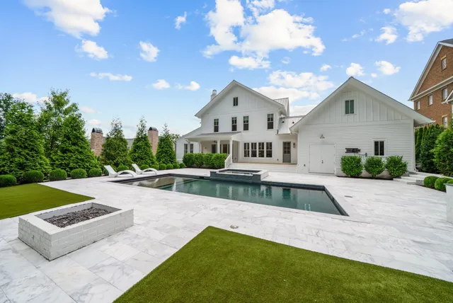 a view of house with swimming pool and yard