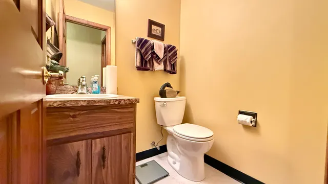 a bathroom with a sink toilet and mirror