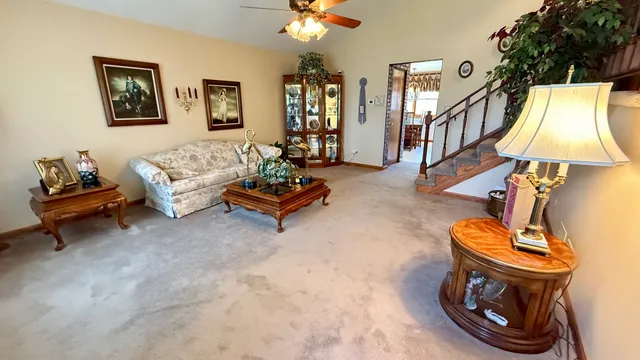 a living room with furniture a couch and a chandelier