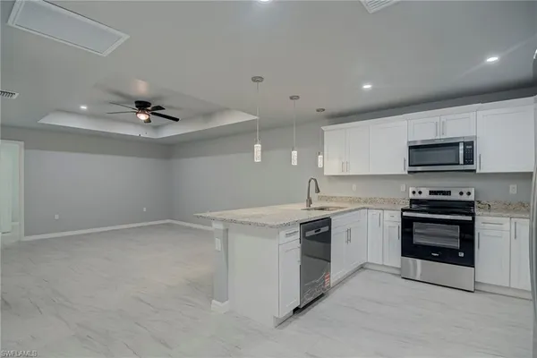 a kitchen with a stove sink and microwave