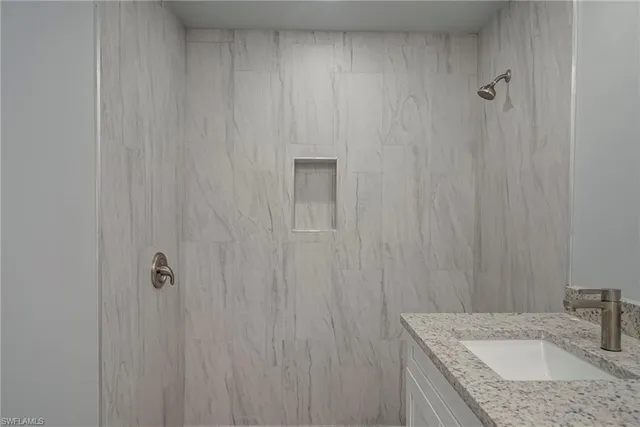 a bathroom with a granite countertop sink and vanity