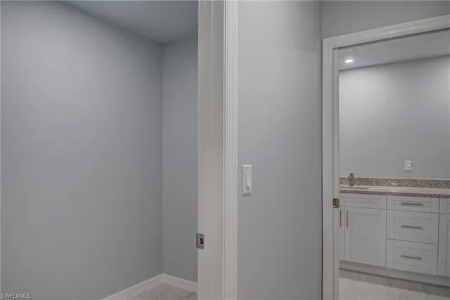 an empty room with an entryway and shower