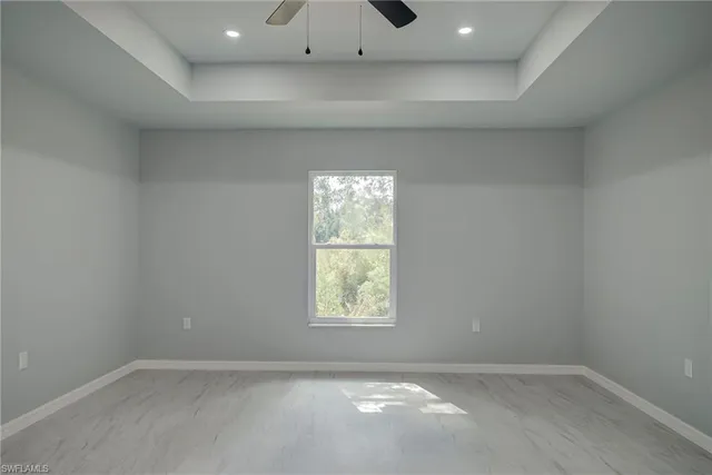 a view of a small space with a window and a ceiling fan
