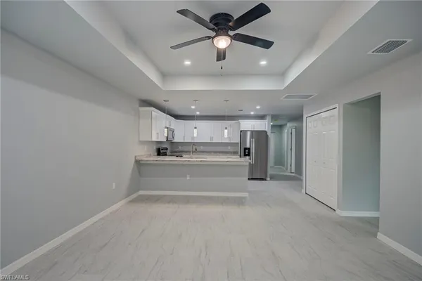 a view of kitchen and kitchen with sink