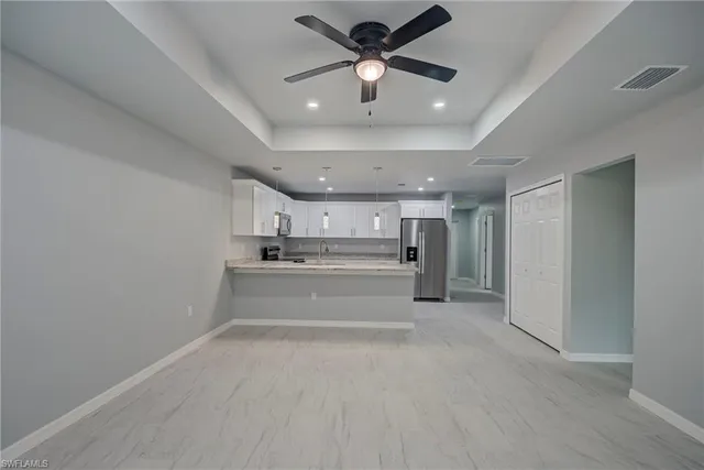 a view of kitchen and kitchen with sink
