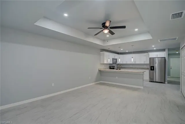 a view of a kitchen with a sink and a stove top oven