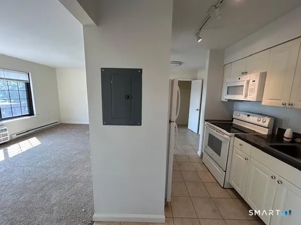 a kitchen with a refrigerator and a stove