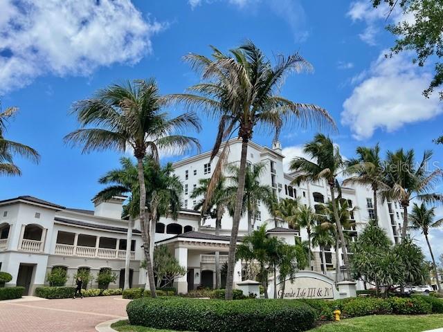 a view of multiple houses with palm trees
