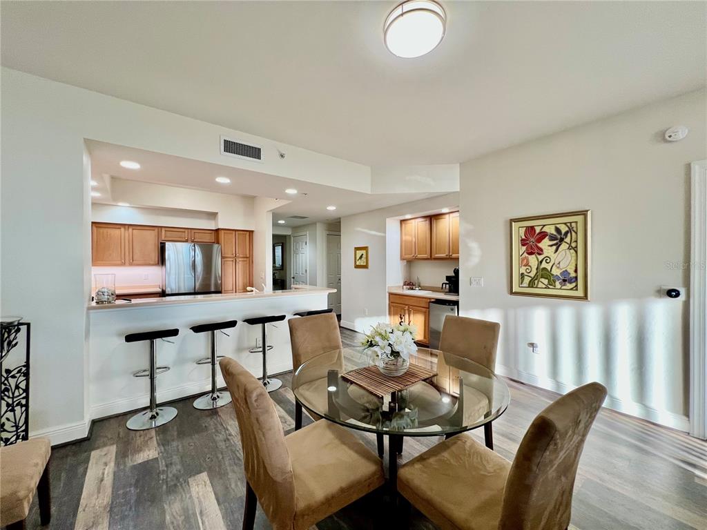 3321 Sunset Key Circle, Unit 102 Punta Gorda, FL 33955 - Photo 17 of 57 a view of a dining room with furniture and wooden floor
