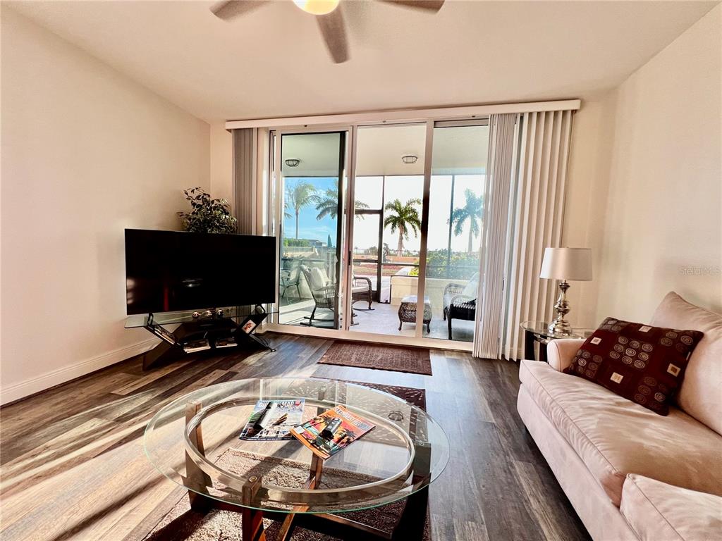 3321 Sunset Key Circle, Unit 102 Punta Gorda, FL 33955 - Photo 18 of 57 a living room with furniture and a flat screen tv