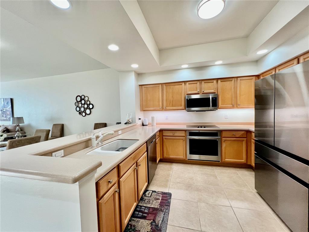 3321 Sunset Key Circle, Unit 102 Punta Gorda, FL 33955 - Photo 22 of 57 a kitchen with stainless steel appliances a stove a sink and a refrigerator