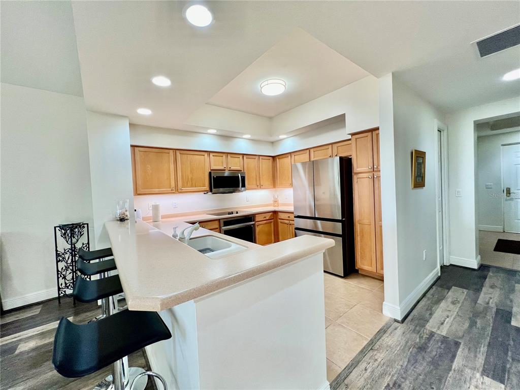 3321 Sunset Key Circle, Unit 102 Punta Gorda, FL 33955 - Photo 25 of 57 a kitchen that has a sink a counter space and a refrigerator