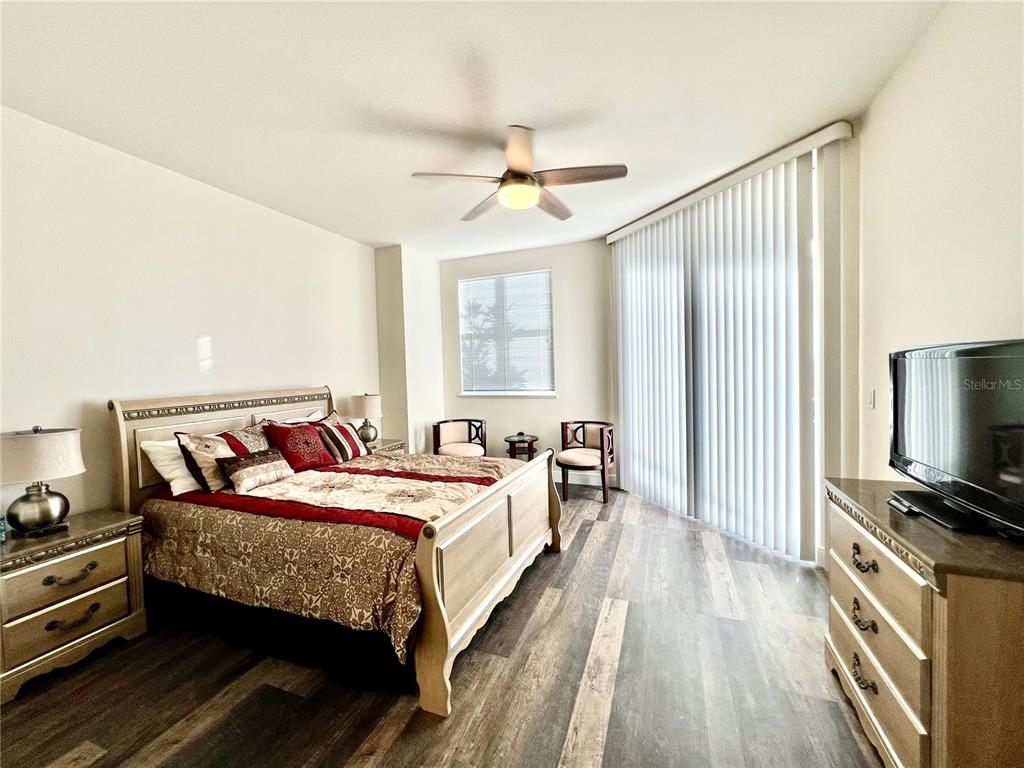 3321 Sunset Key Circle, Unit 102 Punta Gorda, FL 33955 - Photo 27 of 56 a bedroom with a bed and a flat screen tv