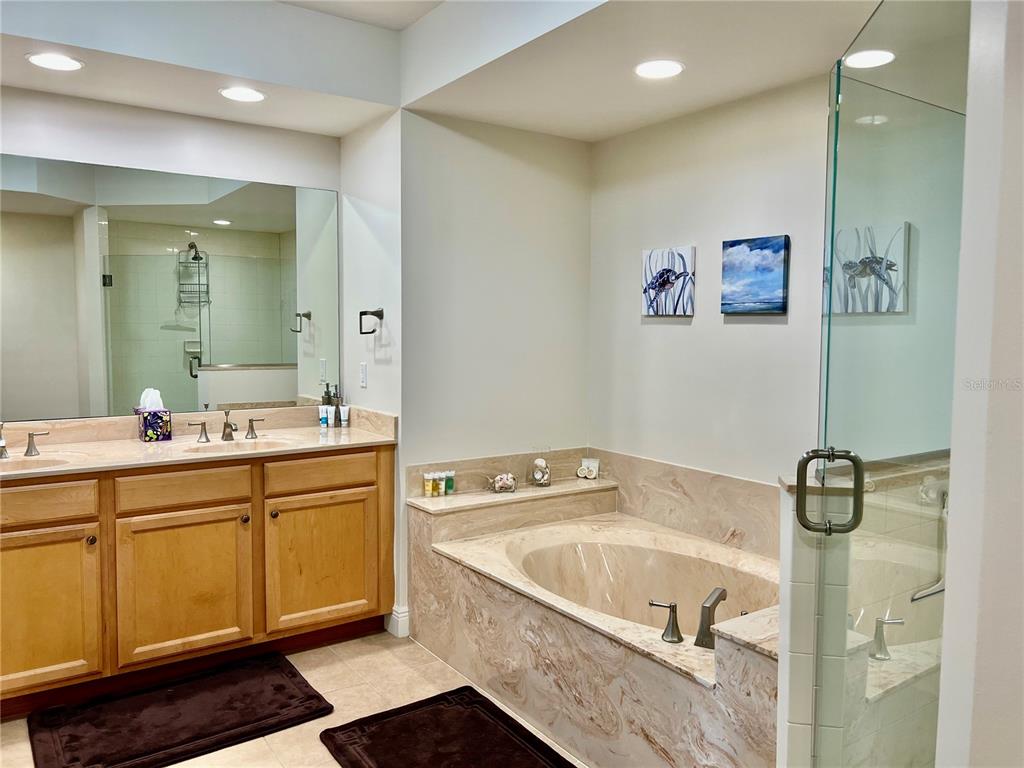 3321 Sunset Key Circle, Unit 102 Punta Gorda, FL 33955 - Photo 28 of 56 a bathroom with a tub sink and mirror