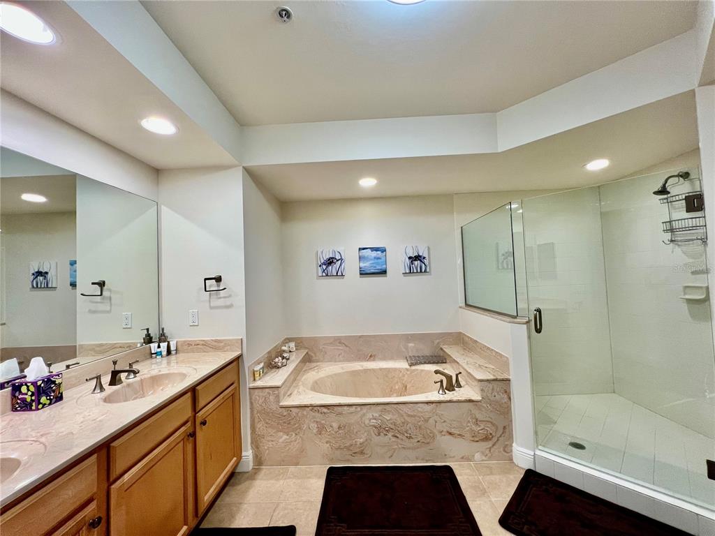 3321 Sunset Key Circle, Unit 102 Punta Gorda, FL 33955 - Photo 29 of 56 a bathroom with a tub a sink and mirror