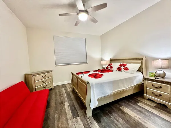 a bedroom with a bed and a ceiling fan