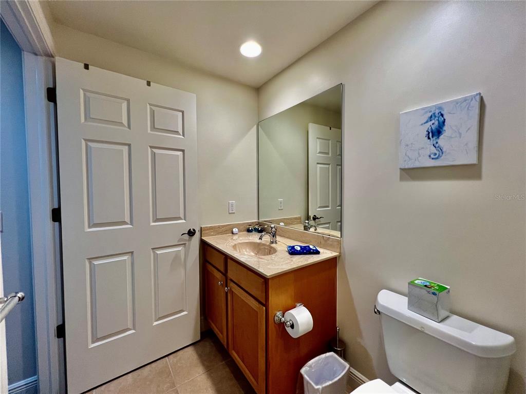 3321 Sunset Key Circle, Unit 102 Punta Gorda, FL 33955 - Photo 33 of 57 a bathroom with a sink mirror vanity and toilet