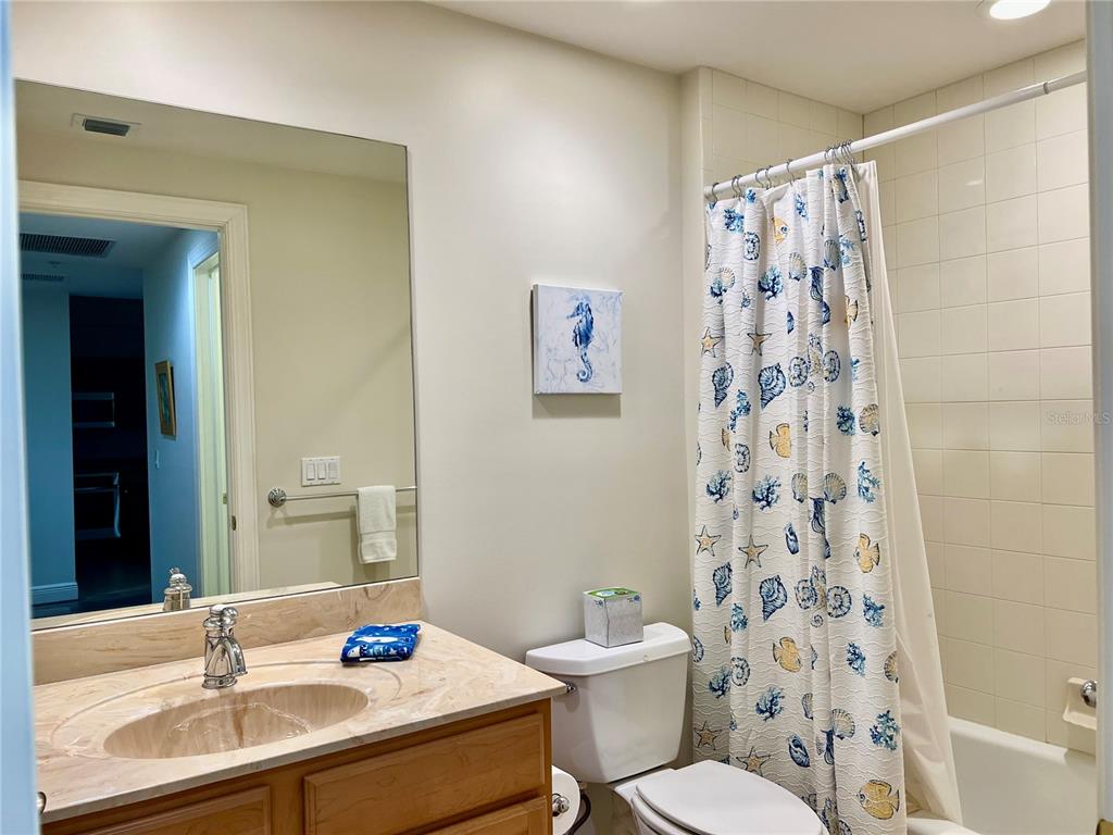 3321 Sunset Key Circle, Unit 102 Punta Gorda, FL 33955 - Photo 35 of 57 a bathroom with a sink toilet a shower and a mirror