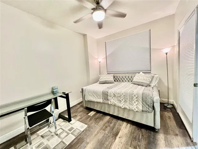 a bedroom with a bed and a mirror