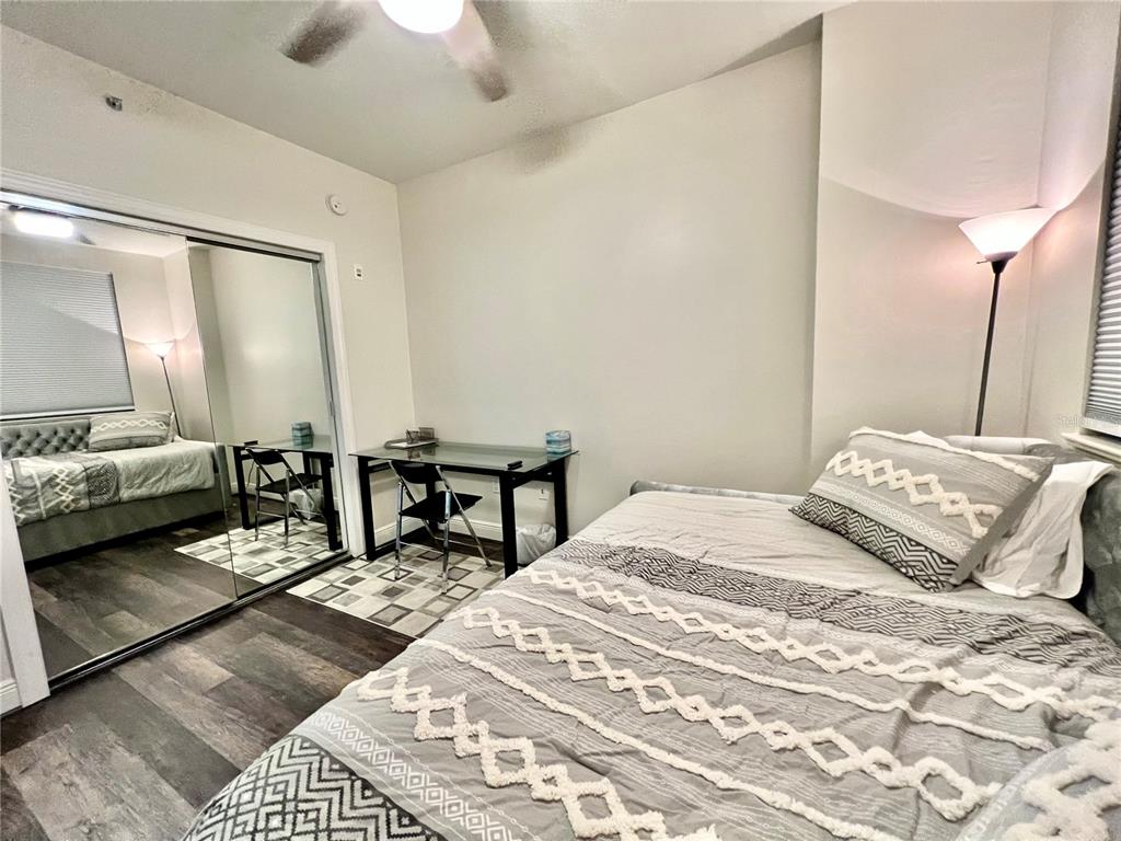 3321 Sunset Key Circle, Unit 102 Punta Gorda, FL 33955 - Photo 36 of 56 a bedroom with a bed a rug and a chandelier