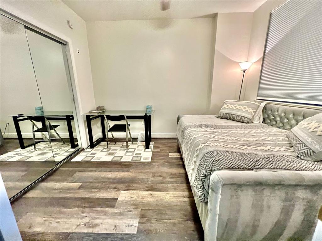 3321 Sunset Key Circle, Unit 102 Punta Gorda, FL 33955 - Photo 37 of 56 a bedroom with a bed and a mirror