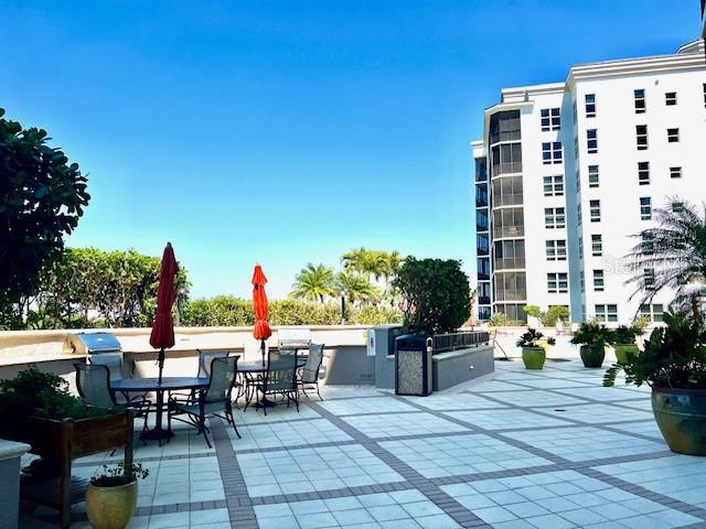 3321 Sunset Key Circle, Unit 102 Punta Gorda, FL 33955 - Photo 41 of 56 a view of a patio with table and chairs and potted plants