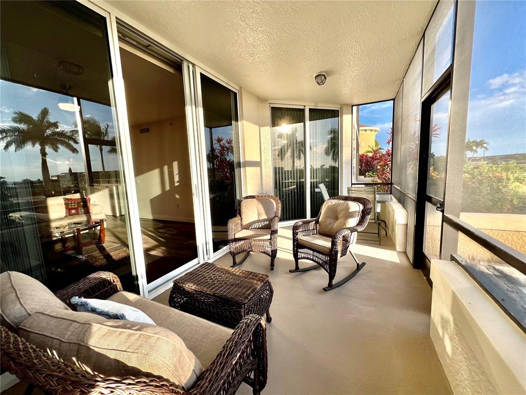 3321 Sunset Key Circle, Unit 102 Punta Gorda, FL 33955 - Photo 7 of 57 a living room with furniture and a floor to ceiling window