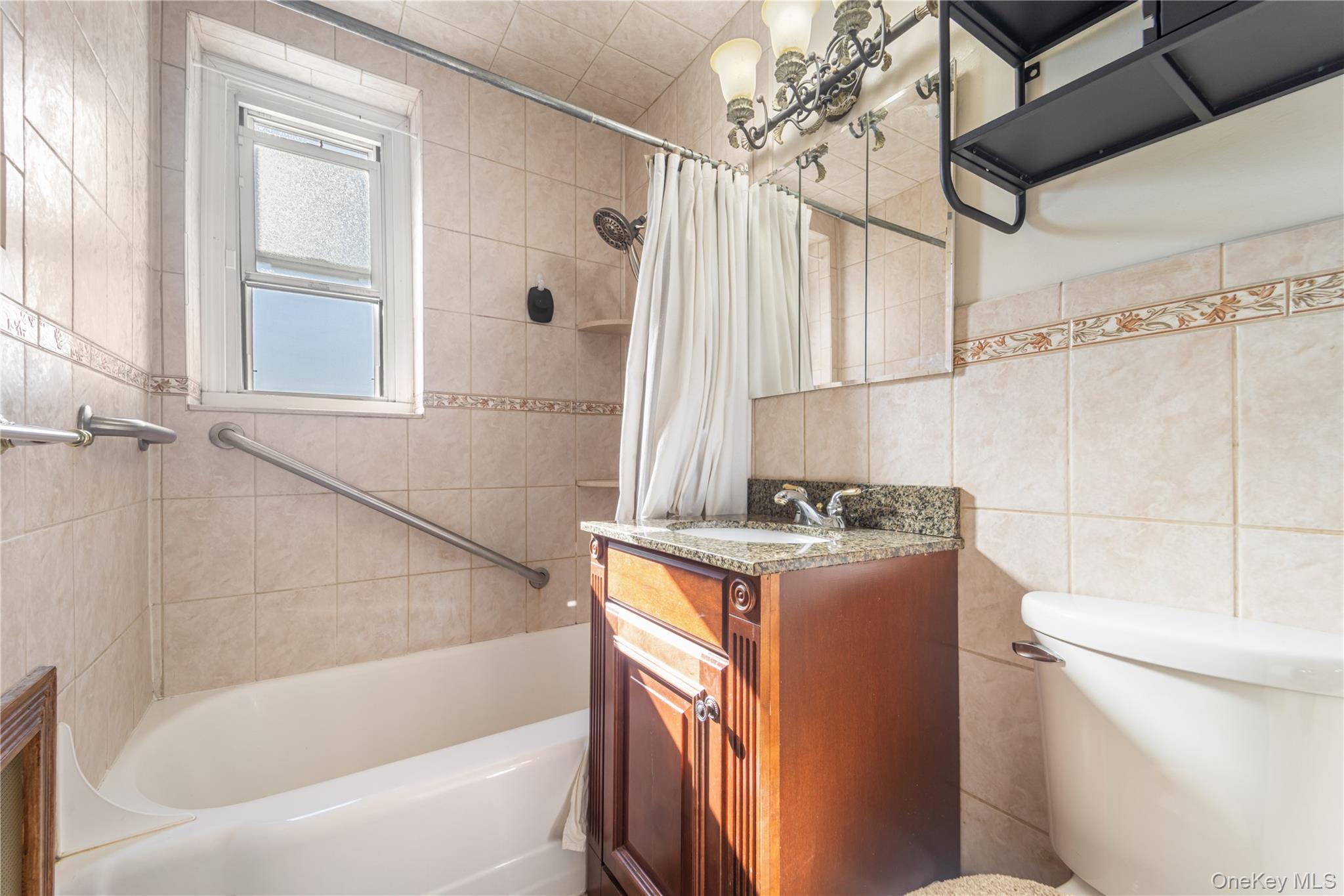 211-40 18th Avenue, Unit 6J Queens, NY 11360 - Photo 11 of 26 a bathroom with a granite countertop sink toilet and shower