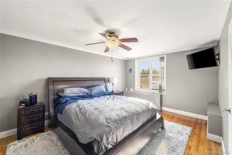 a bedroom with a bed and a tv