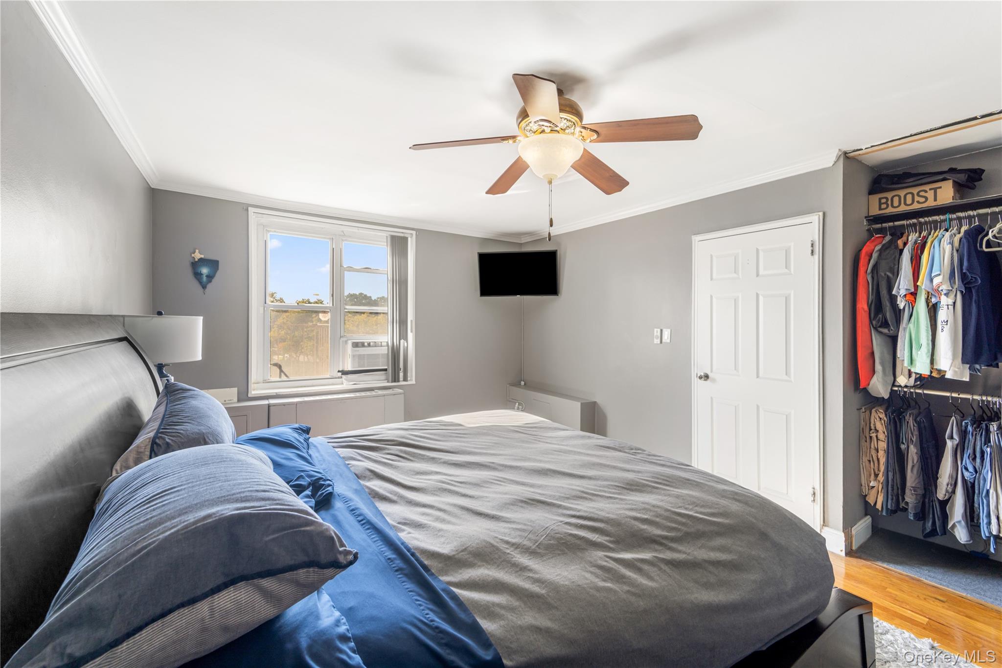 211-40 18th Avenue, Unit 6J Queens, NY 11360 - Photo 15 of 26 a bedroom with a large bed and a window