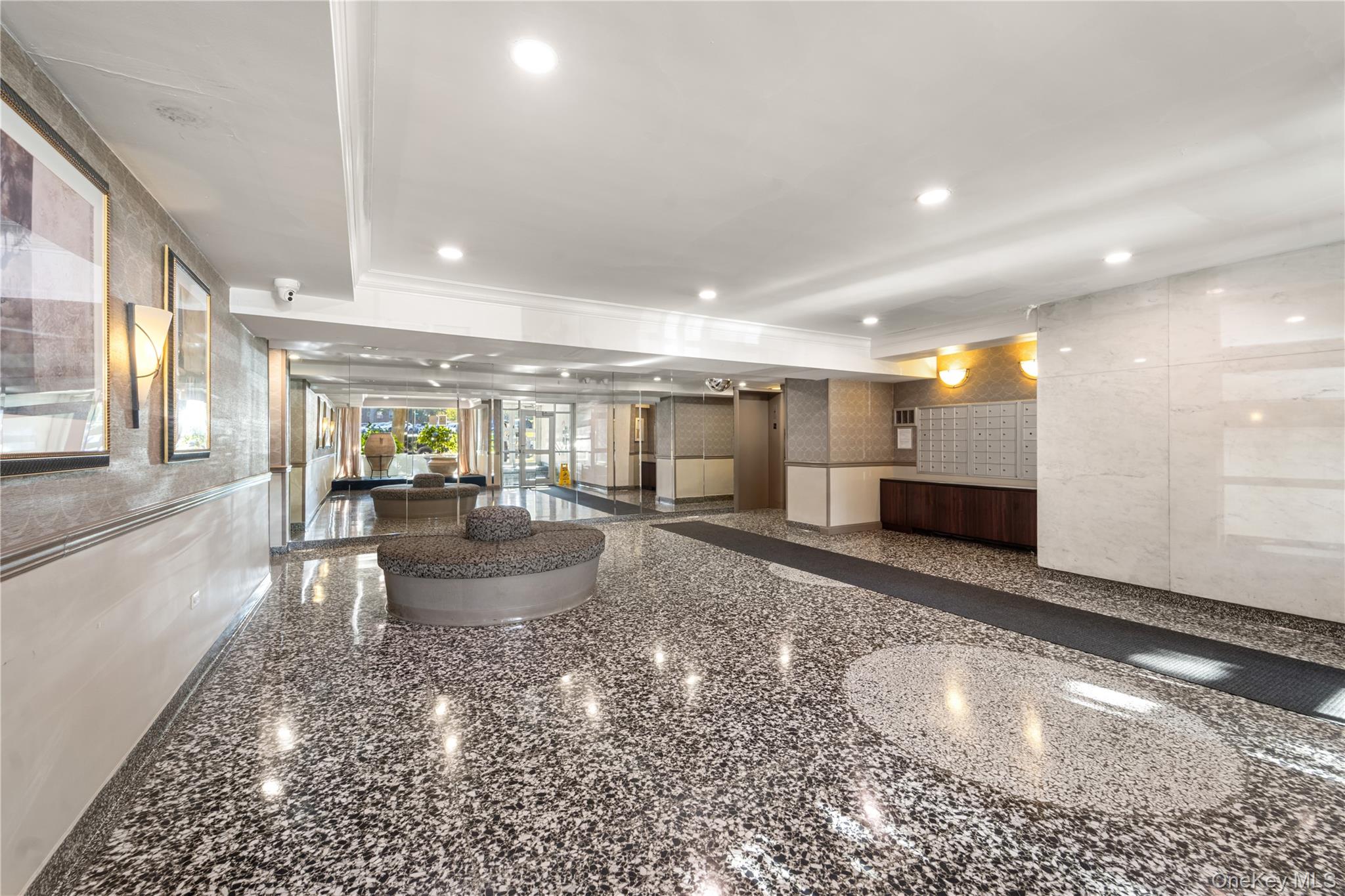 211-40 18th Avenue, Unit 6J Queens, NY 11360 - Photo 19 of 26 a room with a couch and chairs