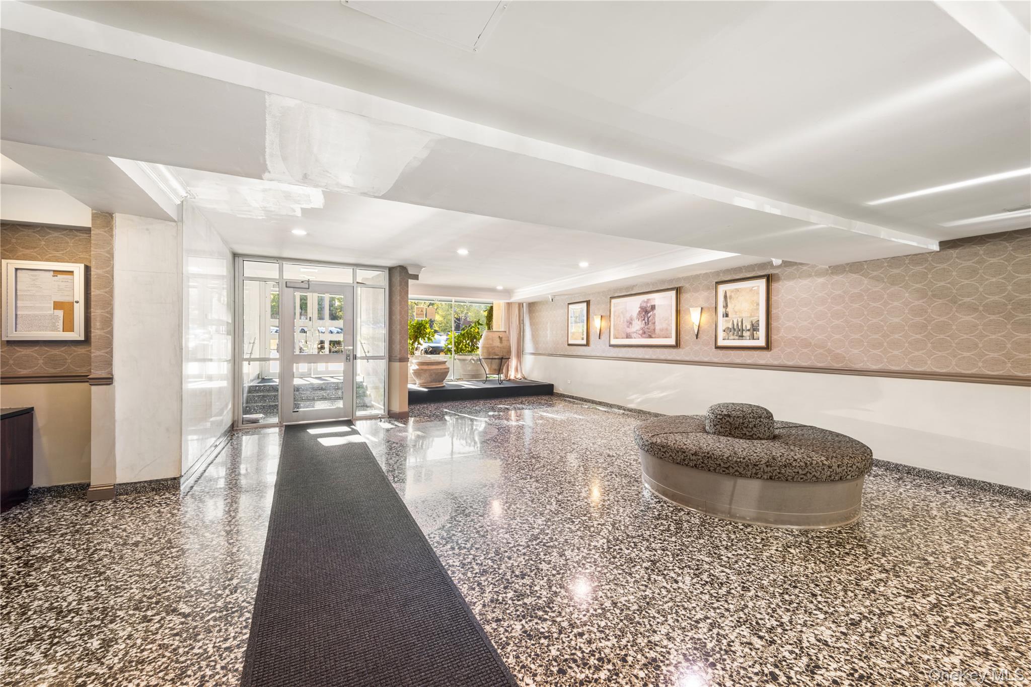 211-40 18th Avenue, Unit 6J Queens, NY 11360 - Photo 20 of 26 a living room with furniture and a wooden floor