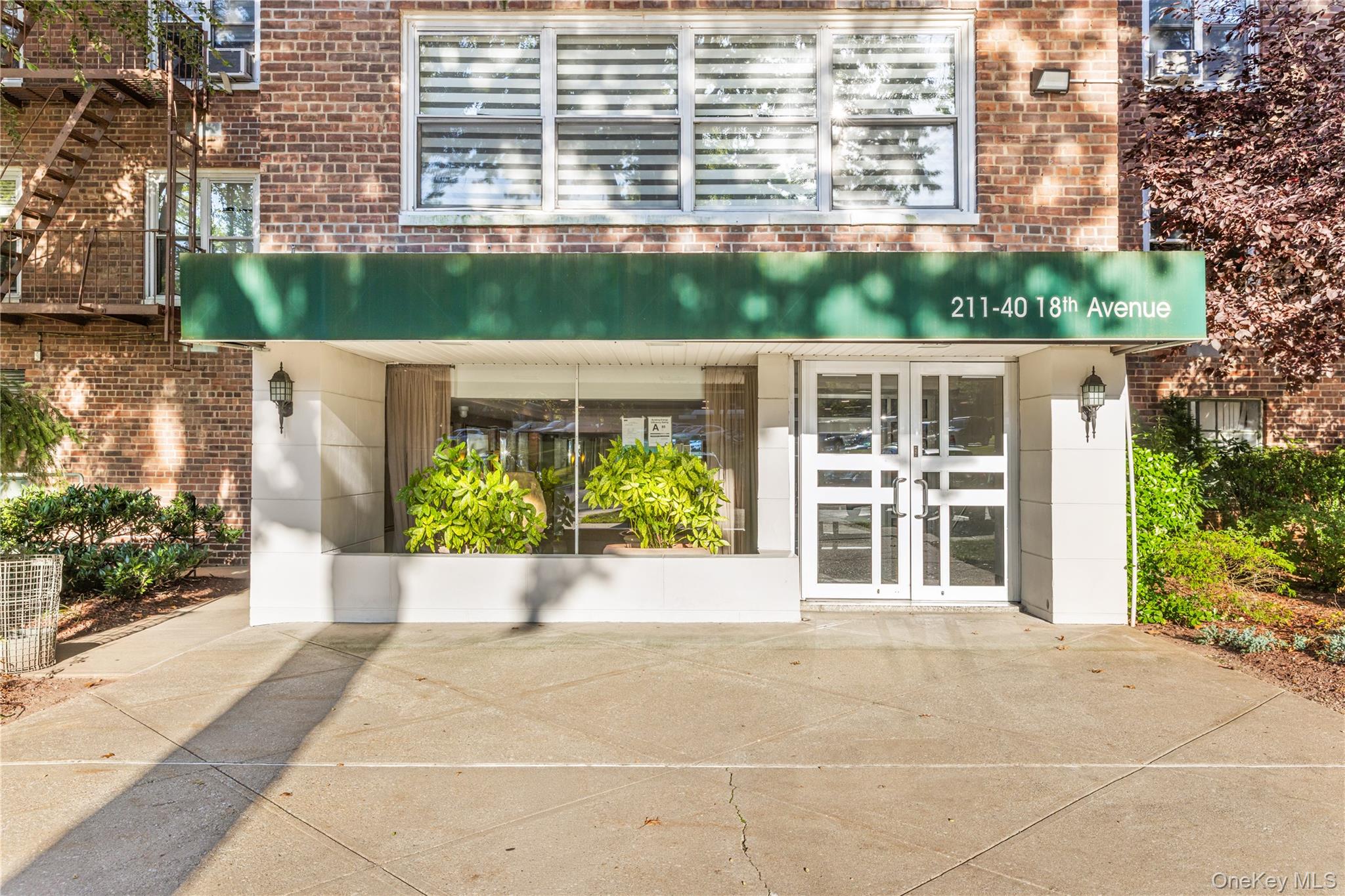 211-40 18th Avenue, Unit 6J Queens, NY 11360 - Photo 23 of 26 a view of a house with potted plants
