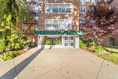 a front view of a building with a garden