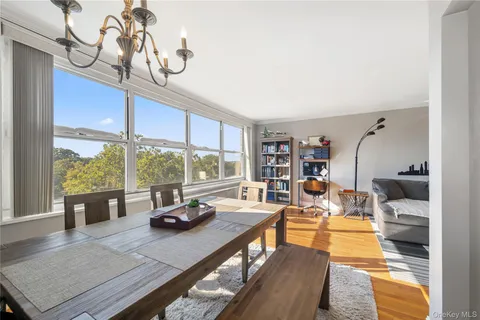 a living room with furniture gym equipment and large windows
