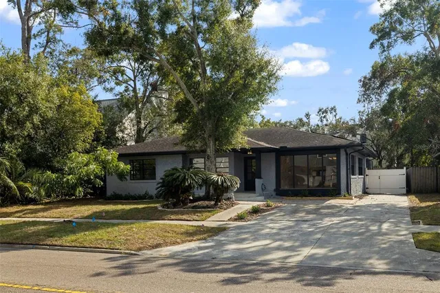 a front view of a house with a yard and a garage