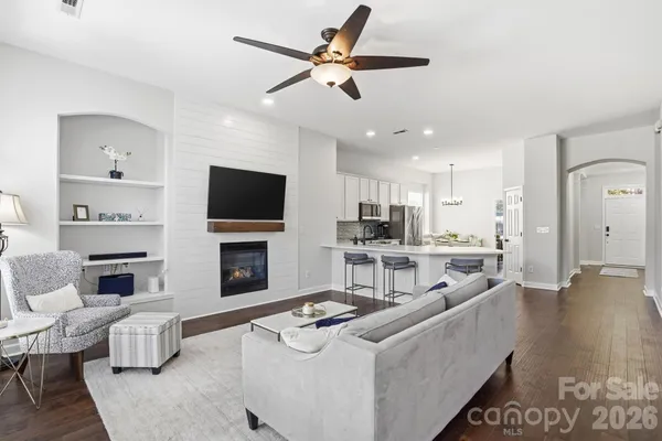 a living room with furniture and a fireplace