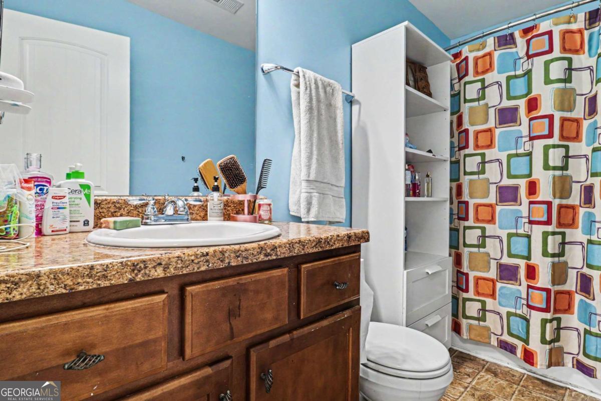 207 George Wynn Road Palmetto, GA 30268 - Photo 27 of 32 a bathroom with a granite countertop sink toilet and shower