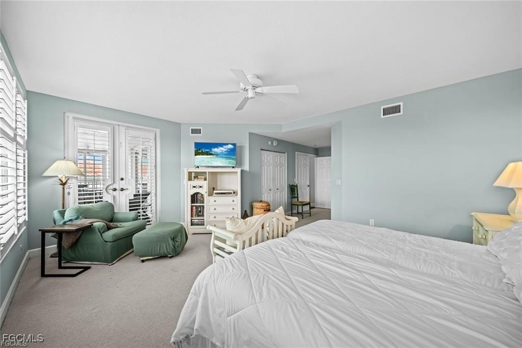2675 Wulfert Road, Unit 6 Sanibel, FL 33957 - Photo 20 of 47 a spacious bedroom with a bed a table and a large window