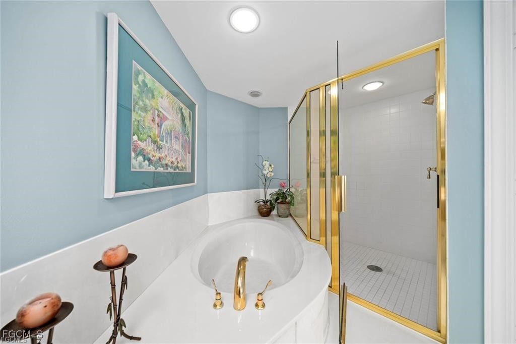 2675 Wulfert Road, Unit 6 Sanibel, FL 33957 - Photo 26 of 47 a bathroom with a tub and shower