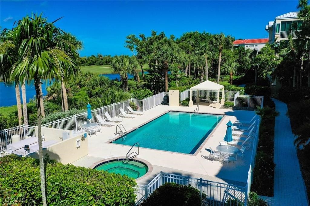 2675 Wulfert Road, Unit 6 Sanibel, FL 33957 - Photo 44 of 47 a view of a patio with table and chairs potted plants with palm trees