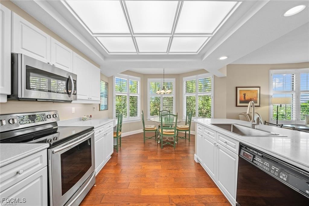 2675 Wulfert Road, Unit 6 Sanibel, FL 33957 - Photo 5 of 47 a kitchen with stainless steel appliances granite countertop a sink a stove and cabinets