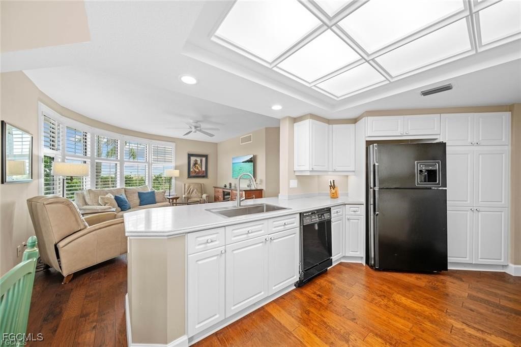 2675 Wulfert Road, Unit 6 Sanibel, FL 33957 - Photo 7 of 47 a large white kitchen with a large window