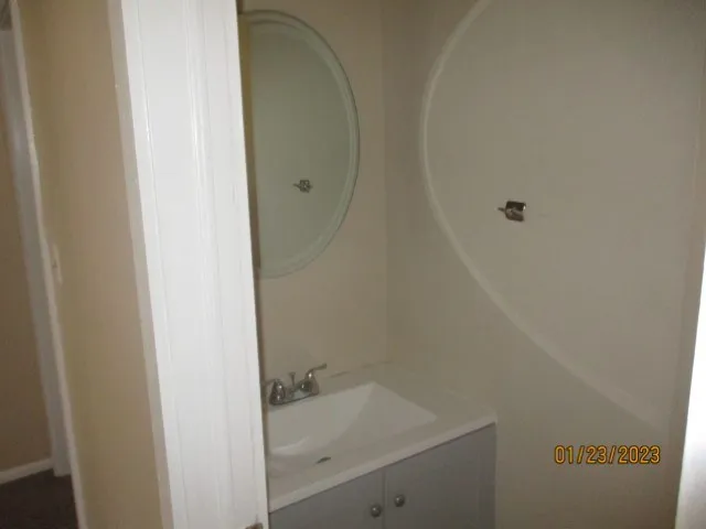 a bathroom with a granite countertop sink and vanity