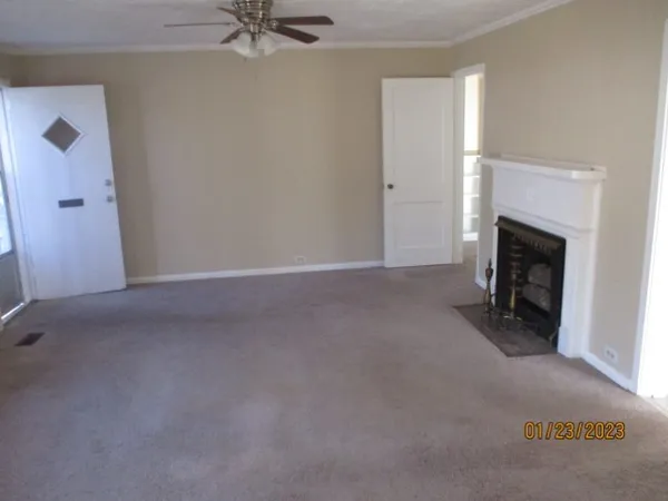 a view of empty room with a fireplace