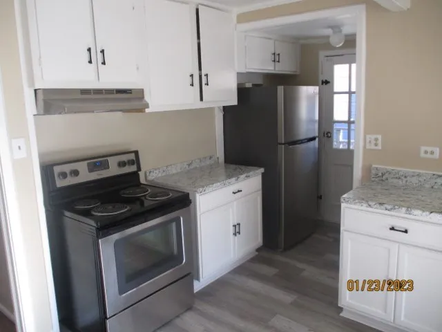 a kitchen with a stove and a refrigerator